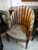 A leather bow chair with lovely patina and mahogany legs