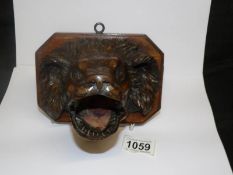 A carved wood spaniel head wall plaque