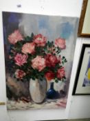 A still life oil painting of flowers signed H.