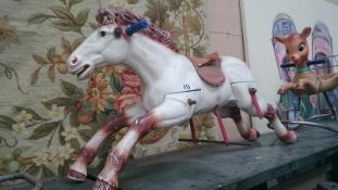 A plastic rocking horse missing frame