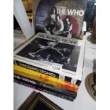 5 boxed music books being 2 The Who, 1 Rolling Stones,