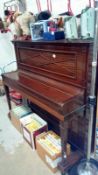 An upright piano by Barratt & Robinson of London