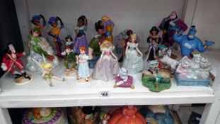 A collection of Disney figurines from Aladdin, Pocahontas,