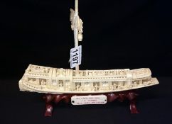 A carved ivory Chinese junk on stand