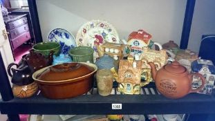 A shelf of teapots etc.