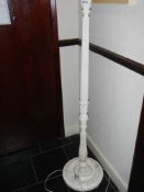 A white painted standard lamp