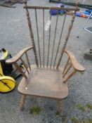 A spindle back low wooden armchair