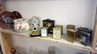 A shelf of mantle clocks