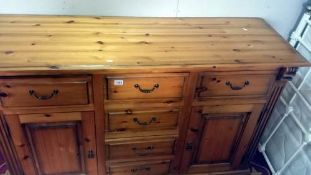 A pine 5 drawer 2 door sideboard