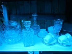 A shelf of glass etc