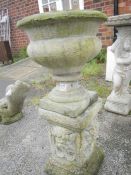 A concrete urn on stand