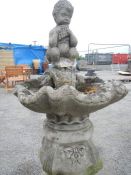 A concrete garden bird bath