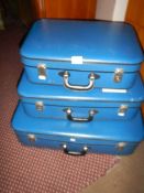 A set of 3 blue suitcases