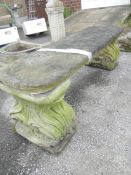 A concrete garden bench