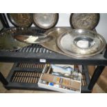 2 shelves containing silverplate and cutlery