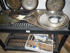 2 shelves containing silverplate and cutlery