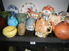 A shelf of teapots etc