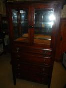A Victorian display cabinet with drop down drawers