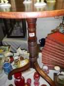 A Victorian tripod tip up table