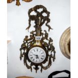 An ornate brass wall clock