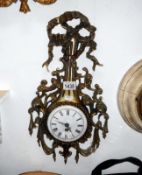An ornate brass wall clock