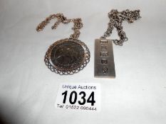 Silver ingot with silver chain and a 1977 silver jubilee crown in silver mount with chain