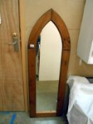 An arched oak framed mirror