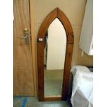 An arched oak framed mirror