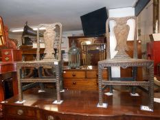 A pair of 19th century heavily carved oak hall chairs depicting musicians in back panel