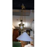 A brass French style rise and fall lamp