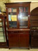 A bookcase with lead glazed doors,