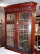 A 19th century glazed corner cabinet