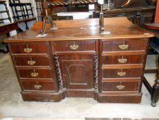A mahogany double pedestal desk with cupboard in center
