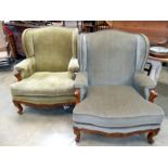 A pair of old wing armchairs with carved wood 'frieze' on scroll feet