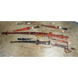 8 African daggers in sheaths and 1 other and a spear head,