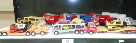 A shelf of small scale Tonka articulated lorries