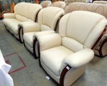 A 3 piece cream faux-leather suite consisting of 3 seater sofa & 2 armchairs