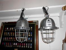 A pair of heavy aluminium industrial style lamps