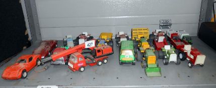 A box of small scale Tonka toys including tractors & Corvette etc.