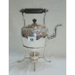 A silver plated kettle on stand