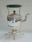 A silver plated kettle on stand