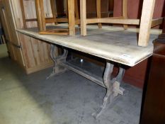 A stripped oak dining table with stretcher