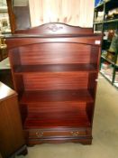 A mahogany 3 shelves book case with drawer