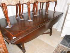 A large inlaid oak dining table with drop leaves