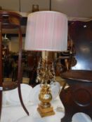 An unusual gilt table lamp with lustre droppers