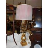 An unusual gilt table lamp with lustre droppers