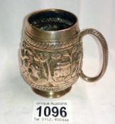 An antique white metal tankard decorated with a lion,