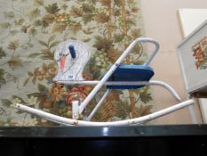 A child's metal frame rocking horse