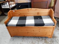 A pine bench with lift up seat
