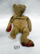 Old teddy bear, in poor condition,